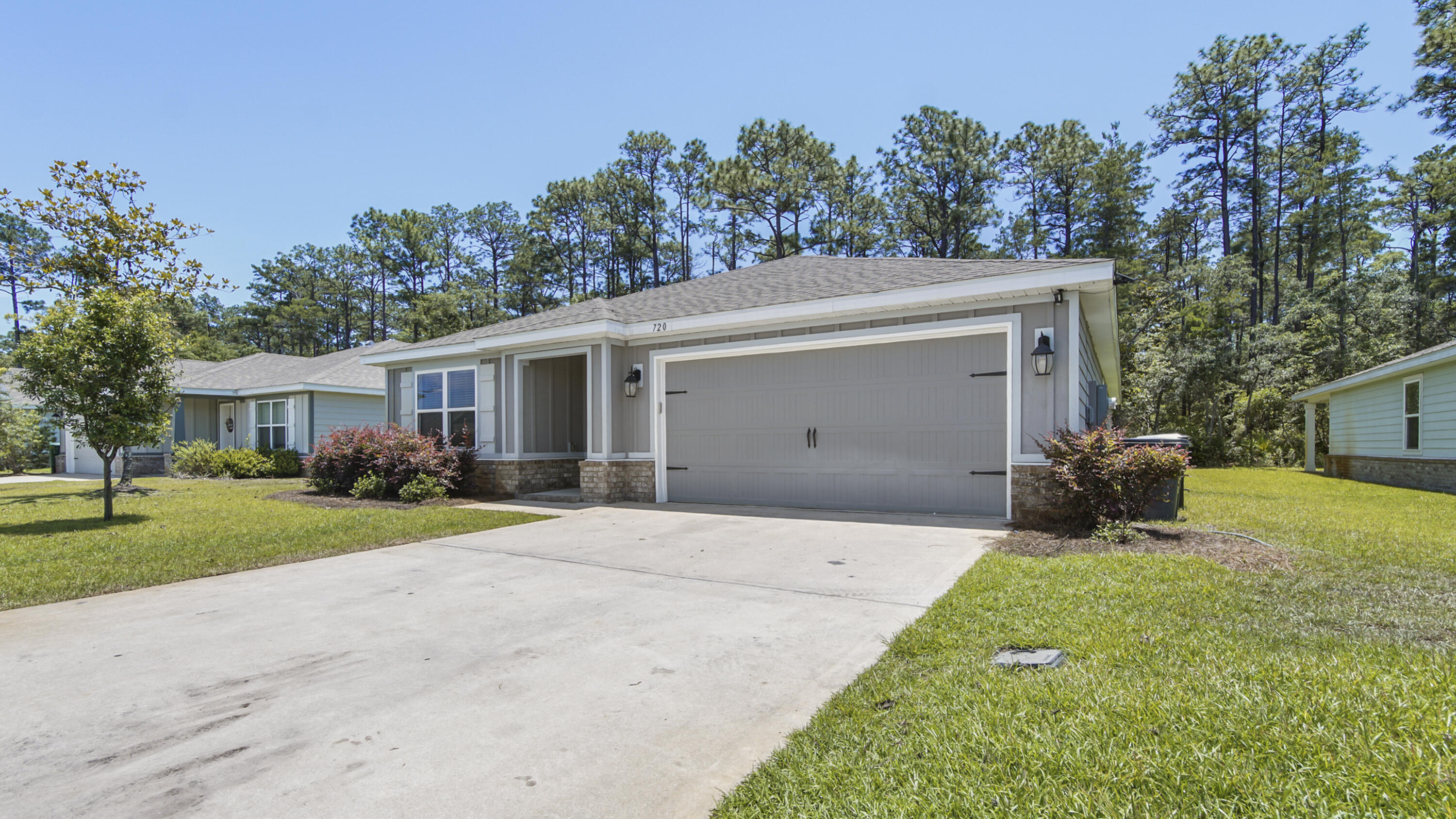 720 Riverwalk Circle Freeport, FL 32439 - Photo 3 of 50 a front view of a house with garden and porch