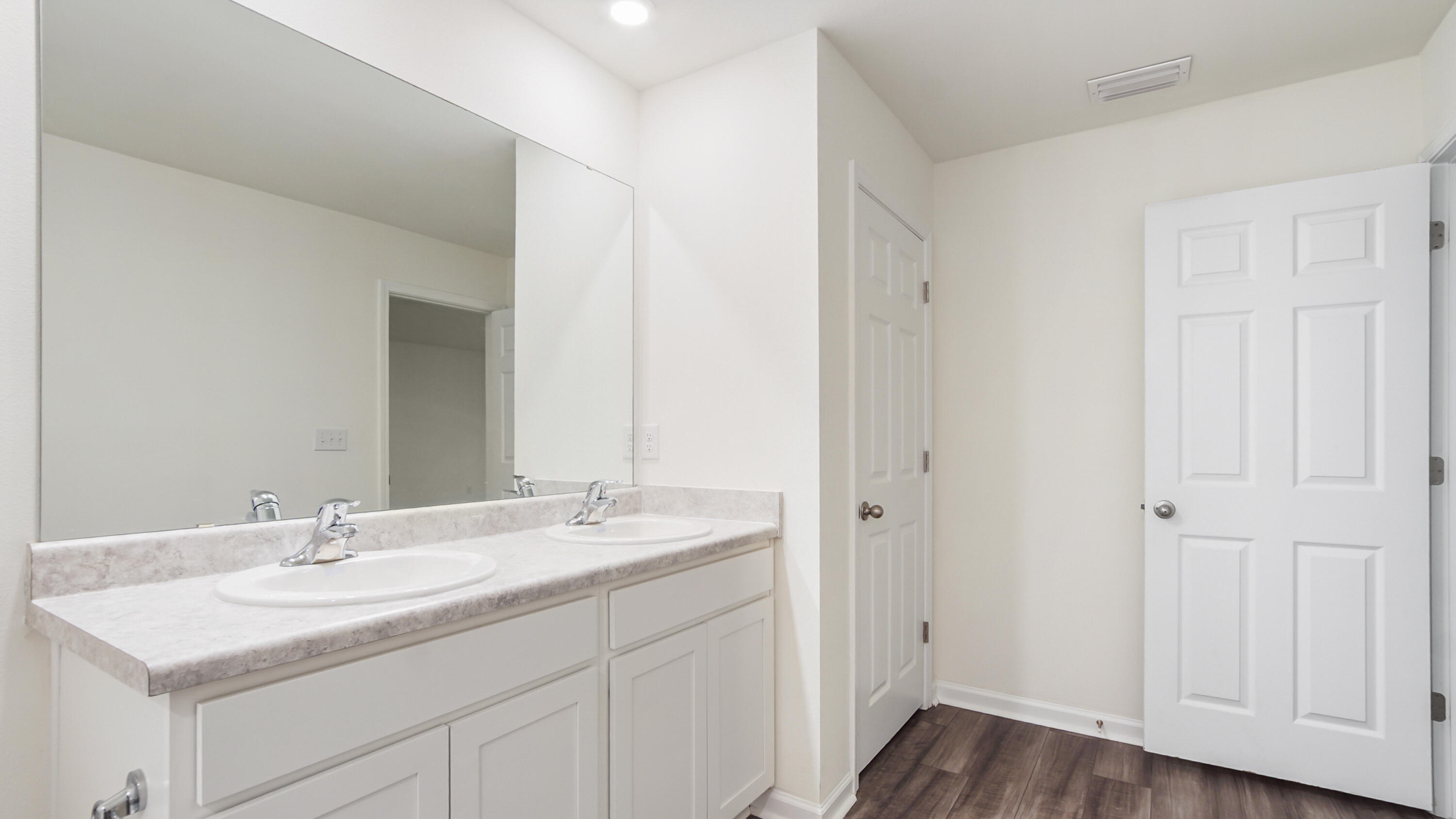 720 Riverwalk Circle Freeport, FL 32439 - Photo 38 of 50 a bathroom with a sink double vanity and a mirror