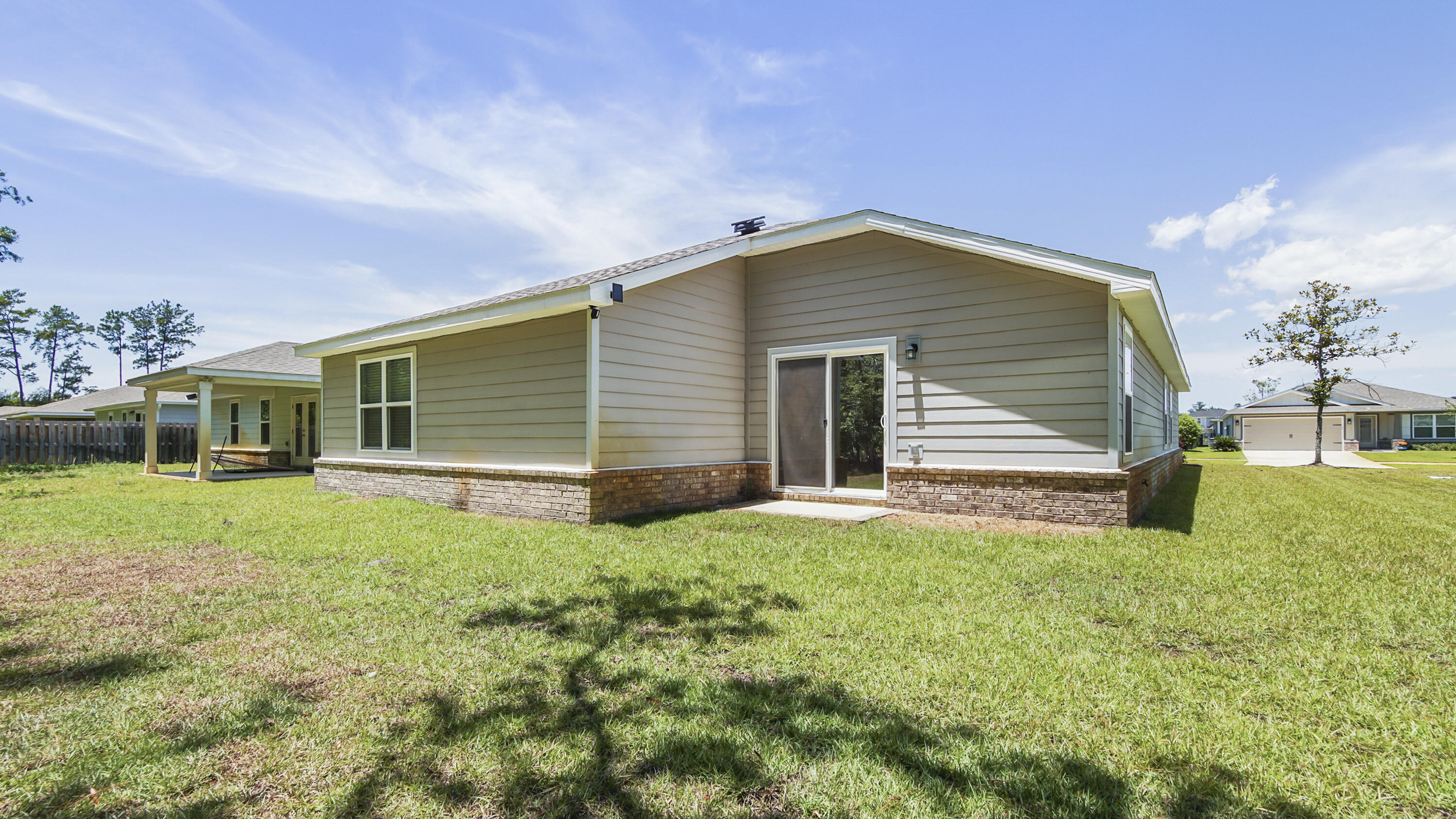 720 Riverwalk Circle Freeport, FL 32439 - Photo 50 of 50 a front view of a house with a garden