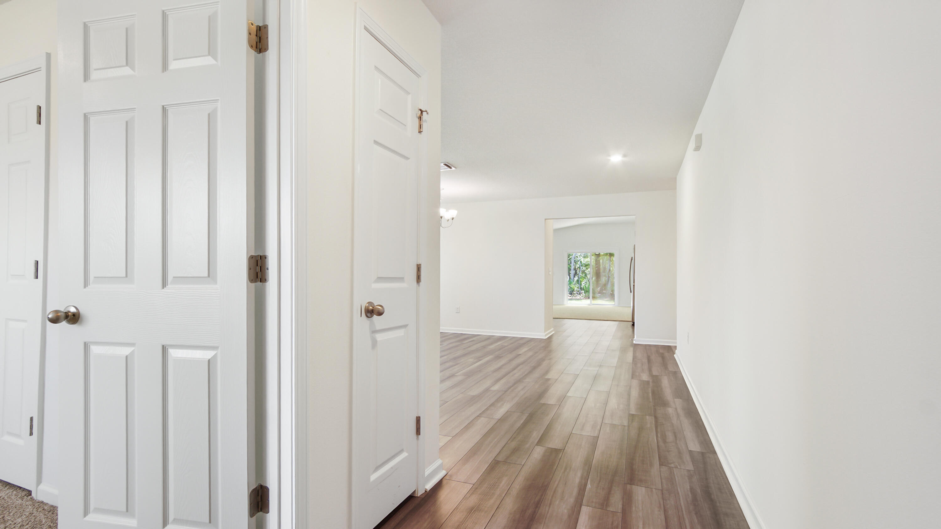 720 Riverwalk Circle Freeport, FL 32439 - Photo 9 of 50 a view of a hallway with wooden floor