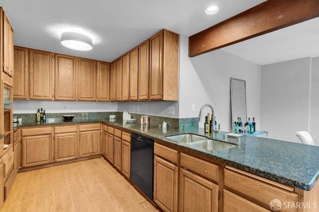 a kitchen with stainless steel appliances granite countertop a stove and a refrigerator