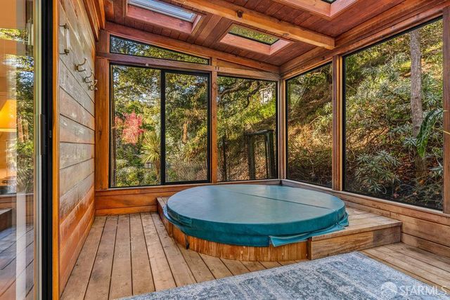 a view of a patio with couches chairs and a wooden floor