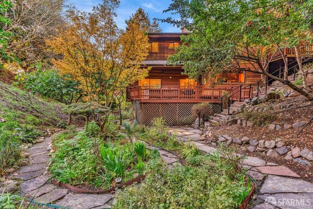 a living room with furniture potted plant and a large window