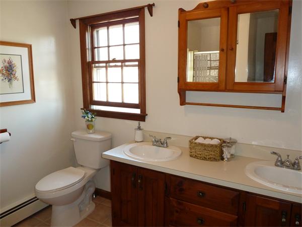 795 Liberty Square Road Boxborough, MA 01719 - Photo 13 of 20 a bathroom with a toilet sink and mirror