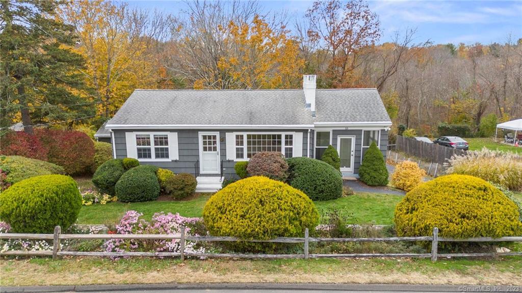 a view of a house with swimming pool and a yard