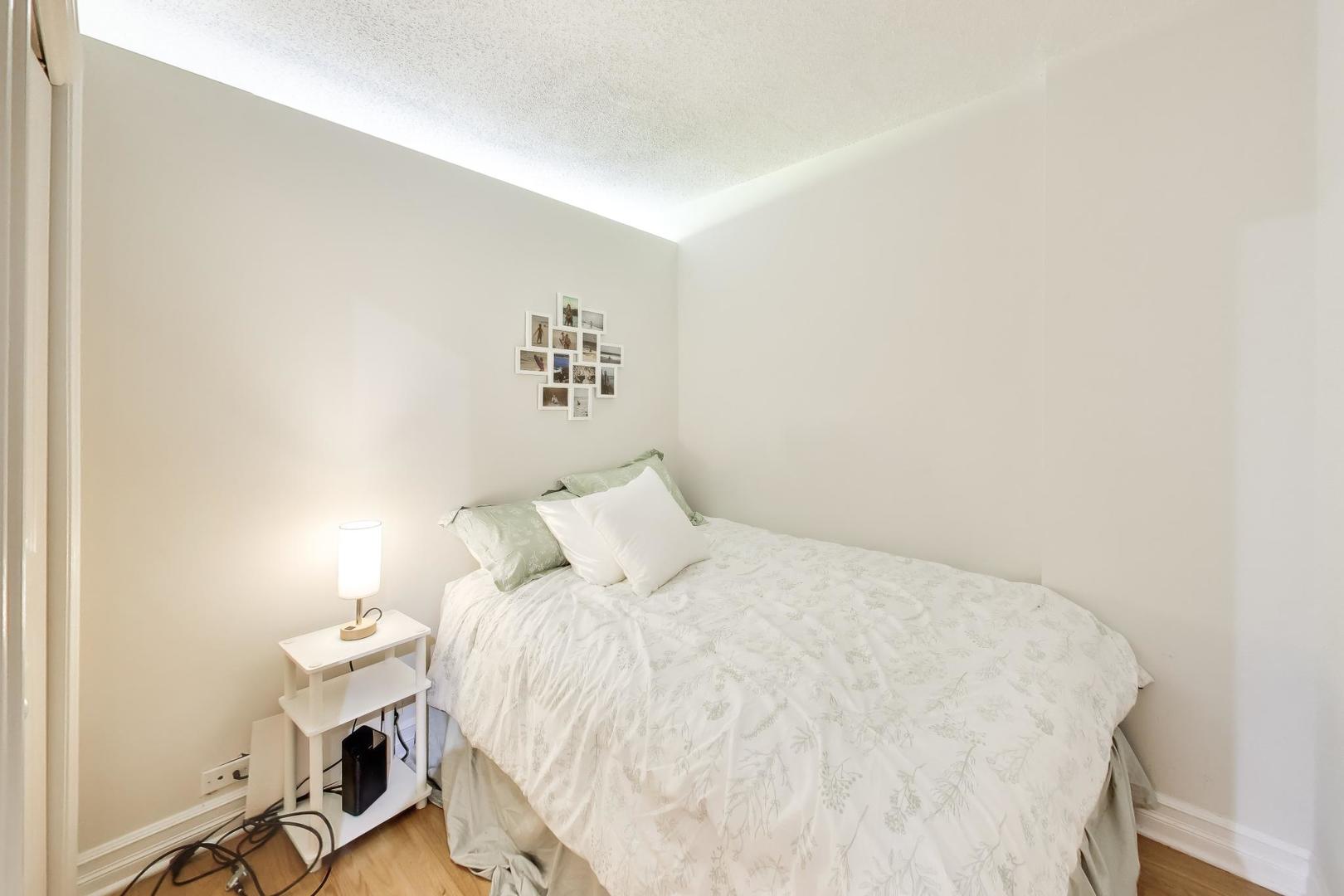 2930 North Sheridan Road, Unit 702 Chicago, IL 60657 - Photo 10 of 25 a bedroom with a bed and a window