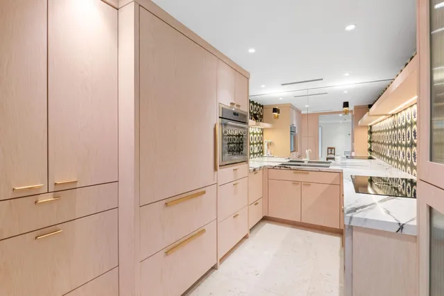a kitchen with granite countertop a sink stove and cabinets