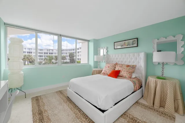 a bedroom with a bed and a lamp