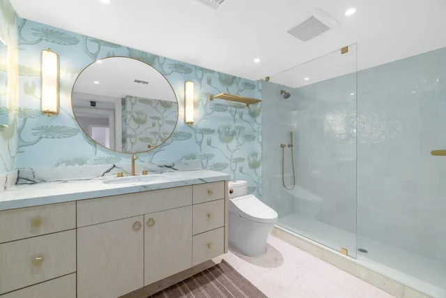 a spacious bathroom with a double vanity sink a toilet and a mirror