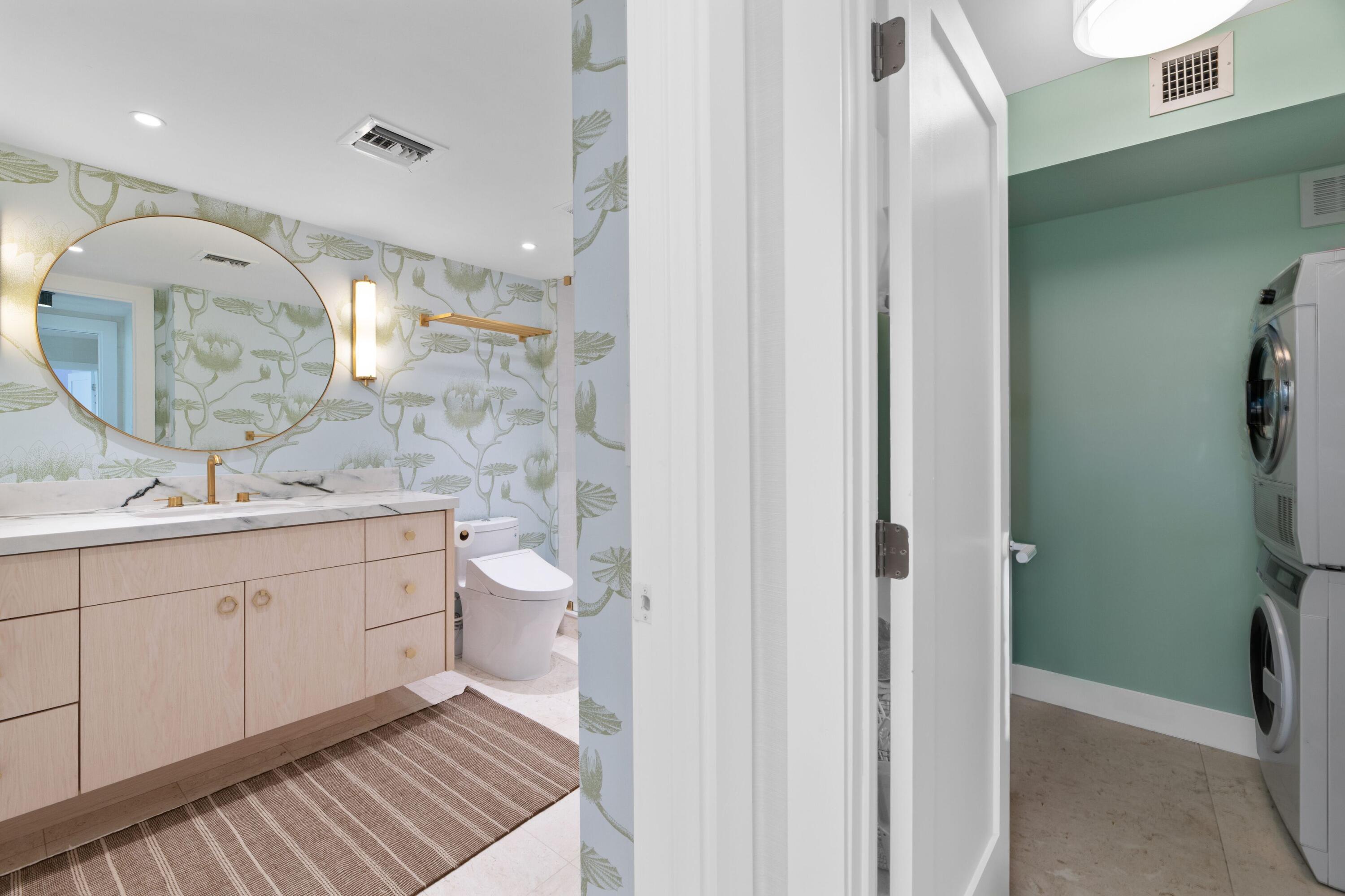 2773 South Ocean Boulevard, Unit 209 Palm Beach, FL 33480 - Photo 20 of 30 a spacious bathroom with a double vanity sink a toilet and a mirror