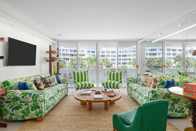 a living room with furniture a rug and a flat screen tv