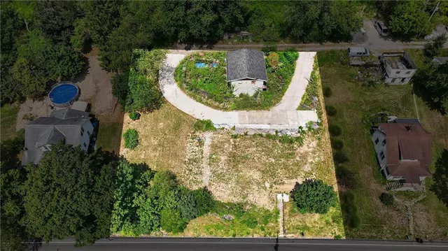 an aerial view of a house with a garden and swimming pool
