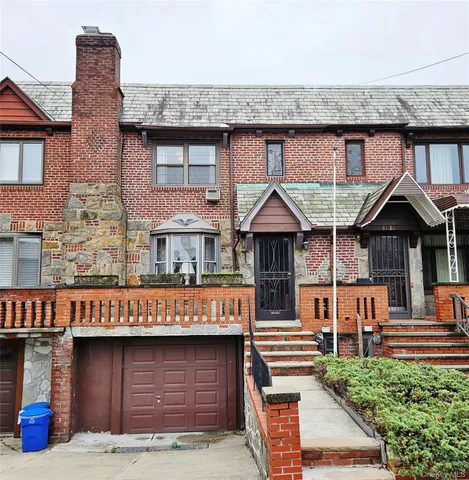 a front view of a house with garage