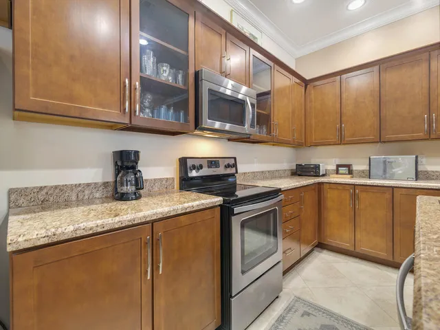 a kitchen with stainless steel appliances granite countertop a sink stove and cabinets