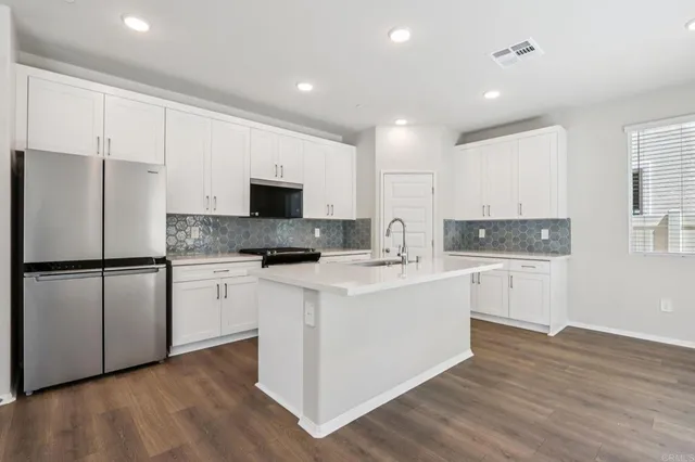a kitchen with a sink stove and cabinets