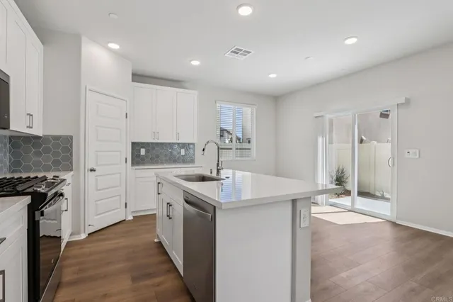 a kitchen with a sink and refrigerator
