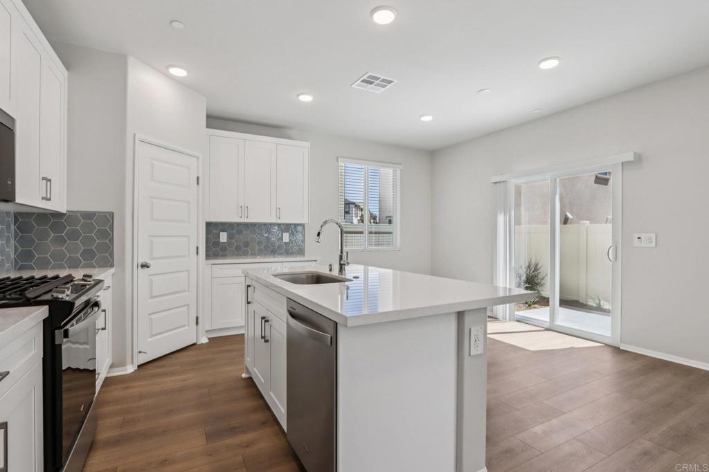 28424 Campos De Flores Temecula, CA 92591 - Photo 14 of 36 a kitchen with a sink stove and cabinets