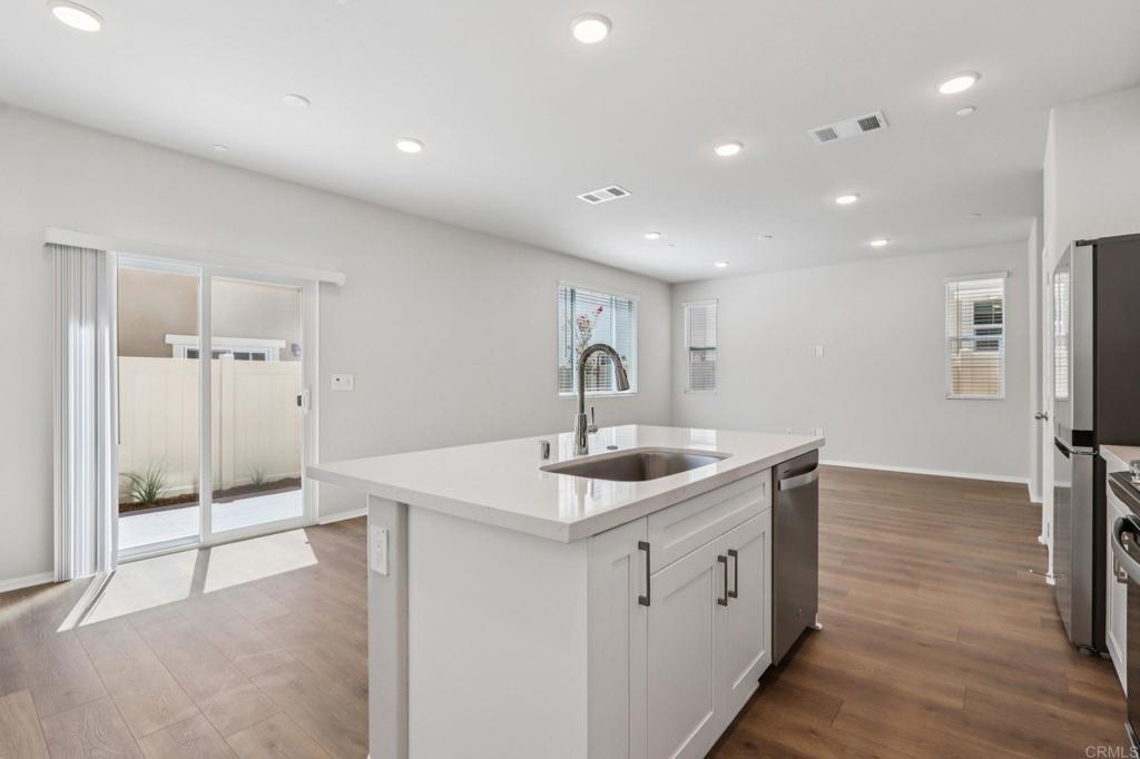 28424 Campos De Flores Temecula, CA 92591 - Photo 15 of 36 a kitchen with a sink and refrigerator