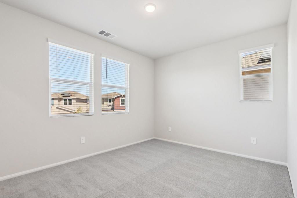 28424 Campos De Flores Temecula, CA 92591 - Photo 18 of 36 an empty room with windows
