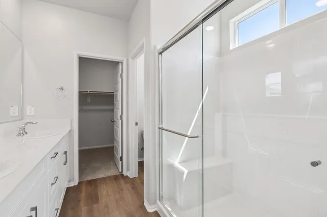 a bathroom with a granite countertop toilet and a shower