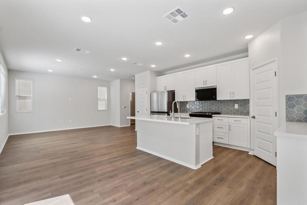 28424 Campos De Flores Temecula, CA 92591 - Photo 10 of 36 a kitchen with stainless steel appliances a refrigerator sink and microwave