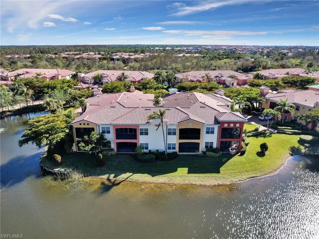 an aerial view of a houses with a lake view