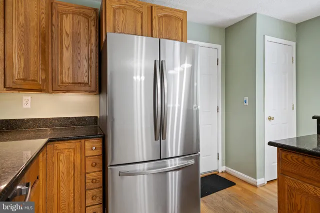 a kitchen with metallic refrigerator freezer and a dishwasher oven