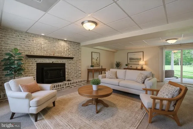 a living room with furniture a table and a fireplace