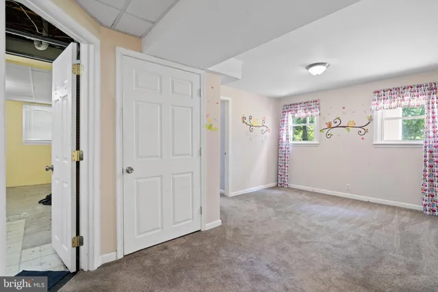 an empty room with windows and closet