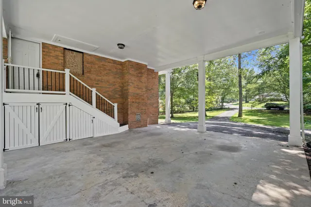 a view of a room with stairs and wooden floor