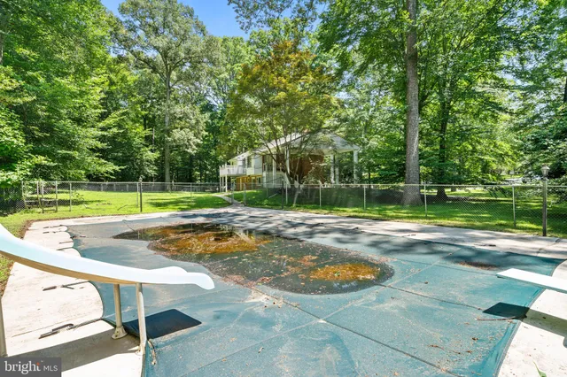a view of a backyard with swimming pool