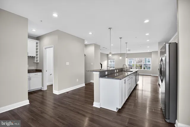 a large kitchen with a lot of counter space and stainless steel appliances