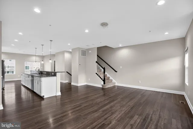 a view of kitchen with cabinets and wooden floor