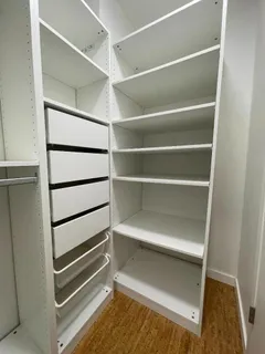 a view of walk in closet with empty racks