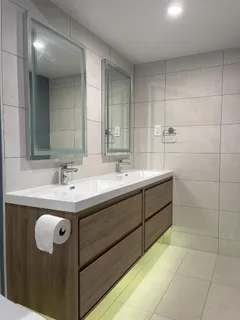a bathroom with a sink double vanity and a mirror