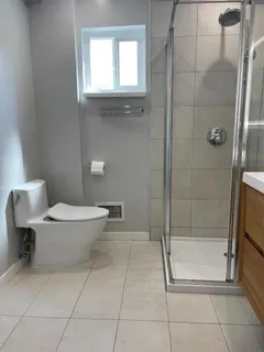 a bathroom with a toilet and a shower