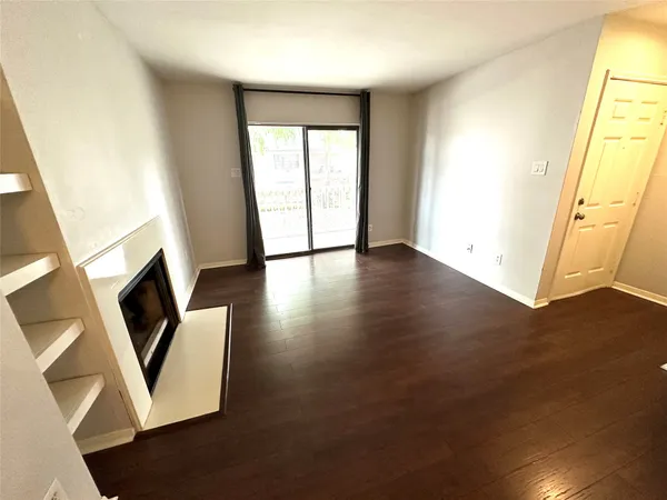 an entryway with wooden floor and windows