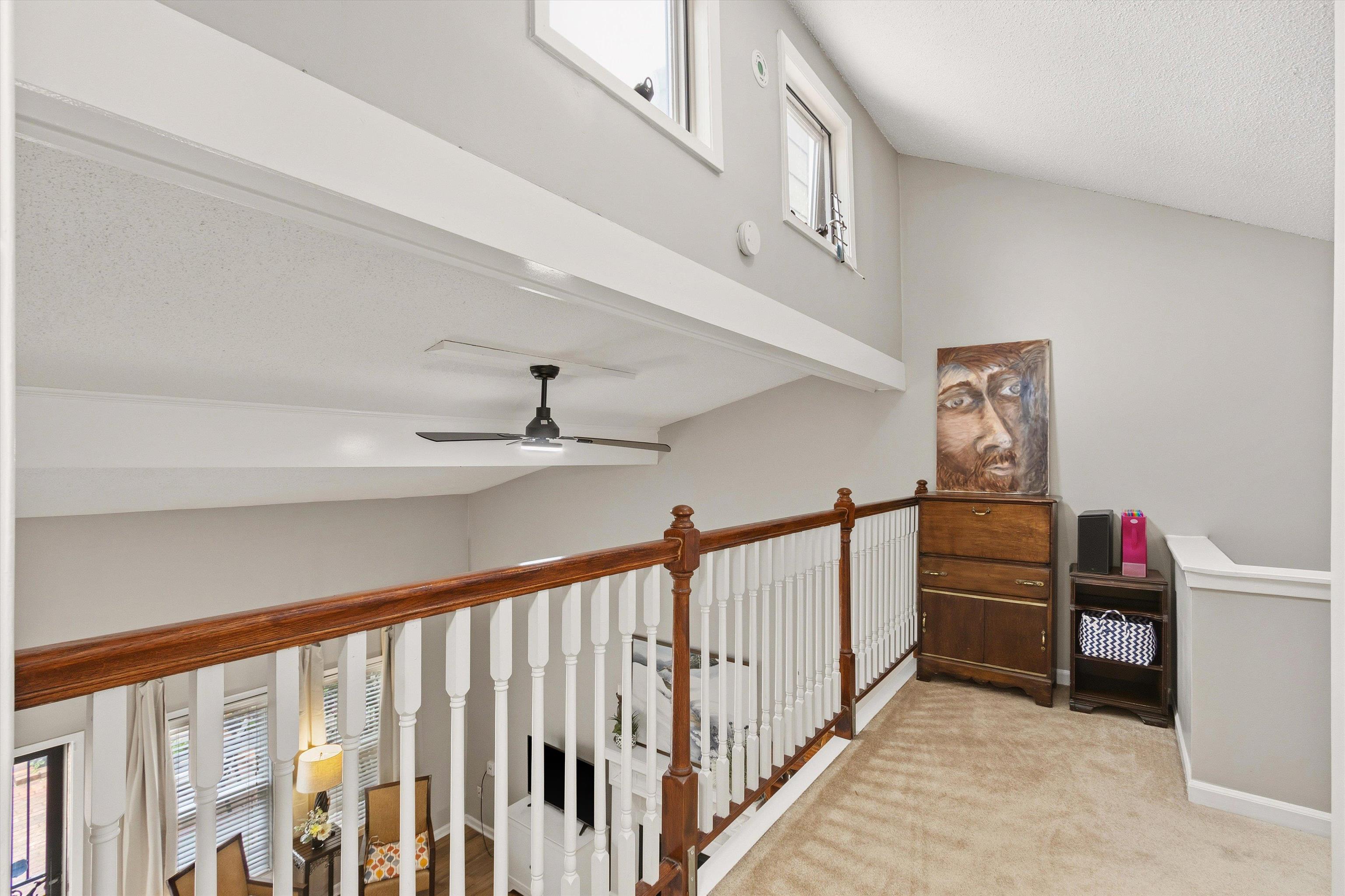 1906 Allenby Road, Unit 16 Germantown, TN 38139 - Photo 16 of 31 Carpeted loft with a wood-finish railing, white balusters, and a vaulted ceiling