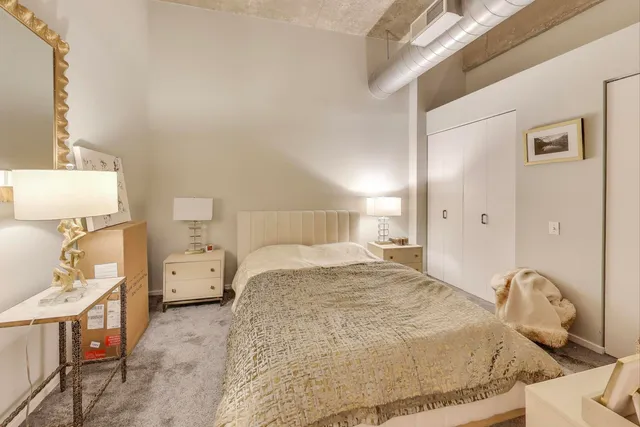 a bedroom with a bed and a mirror