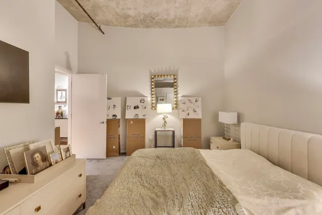 a bedroom with a bed and dresser