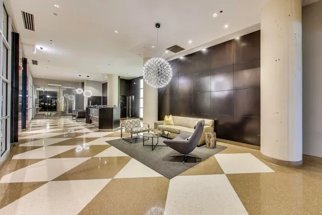 a living room with furniture and a chandelier