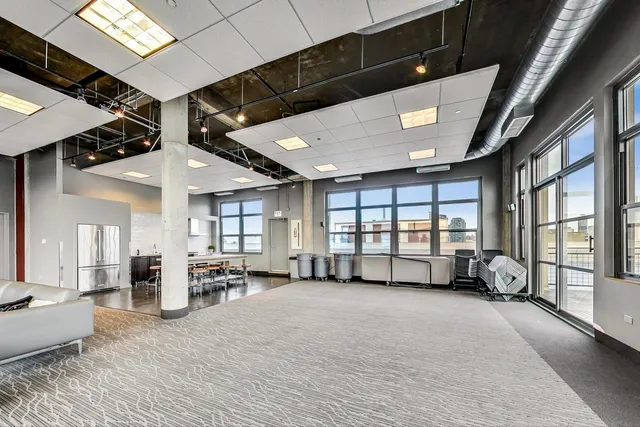 a large hall with a lots of windows and couch