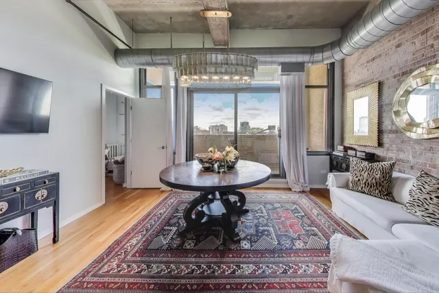 a living room with furniture and a chandelier