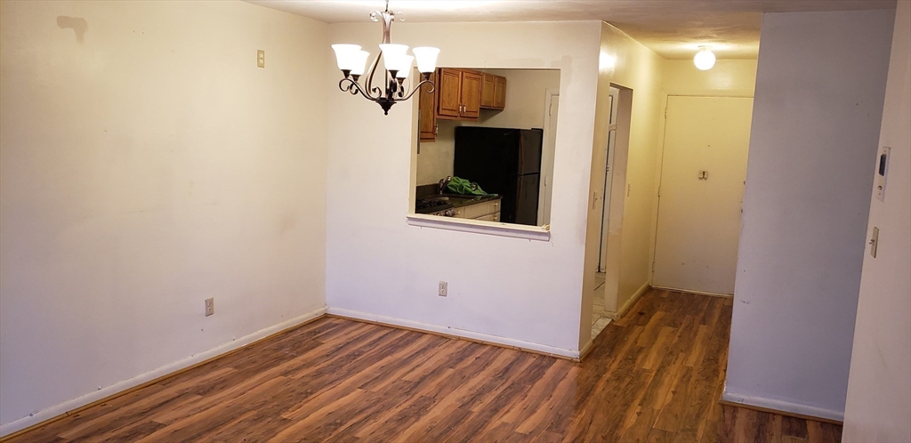 6 Hayes Road, Unit 25 Boston, MA 02131 - Photo 11 of 39 a view of a hallway with wooden floor and staircase