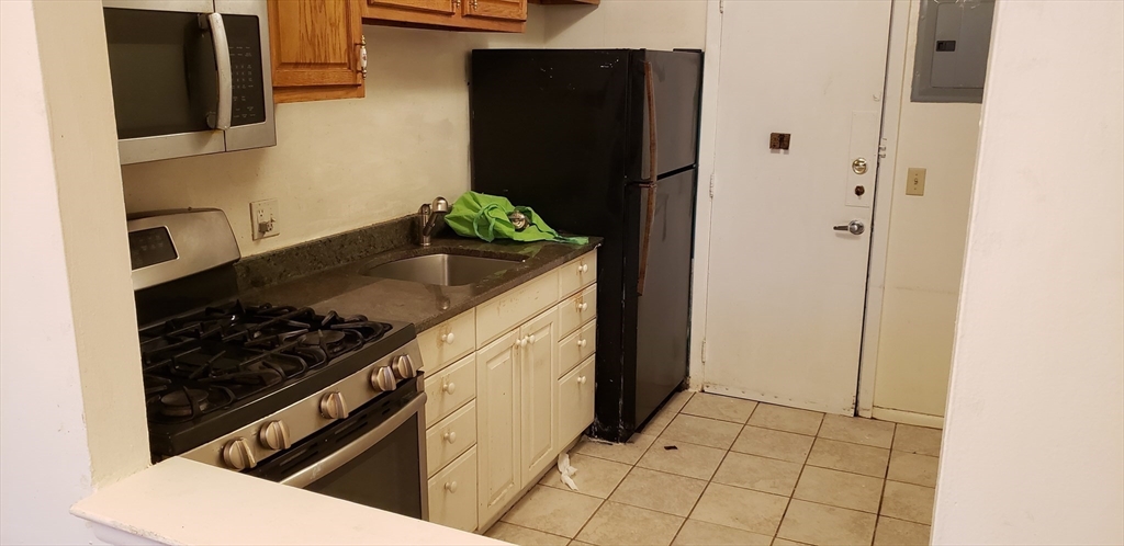 6 Hayes Road, Unit 25 Boston, MA 02131 - Photo 12 of 39 a kitchen with stainless steel appliances granite countertop a refrigerator and a stove