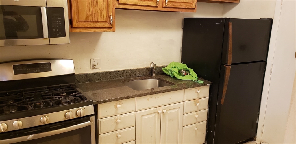 6 Hayes Road, Unit 25 Boston, MA 02131 - Photo 13 of 39 a kitchen with a refrigerator and a stove