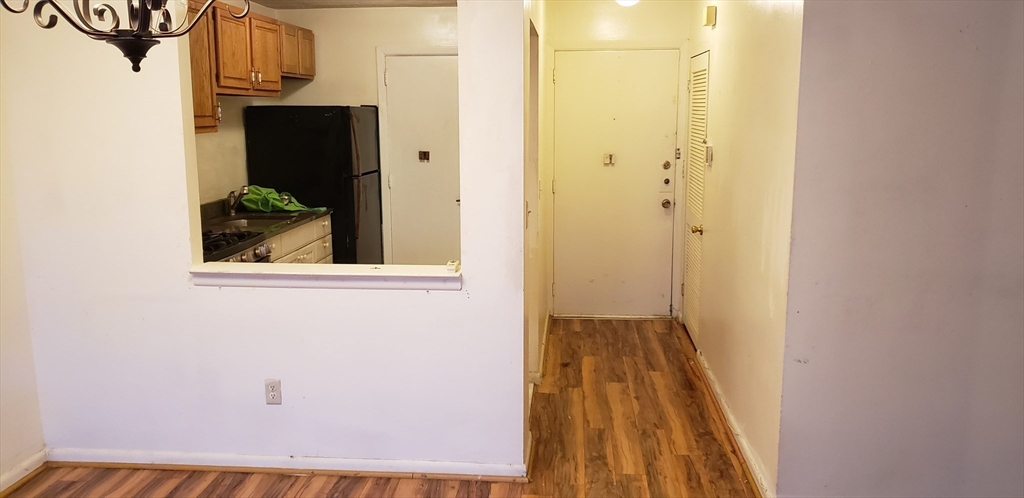 6 Hayes Road, Unit 25 Boston, MA 02131 - Photo 14 of 39 a view of a hallway with wooden floor and entryway