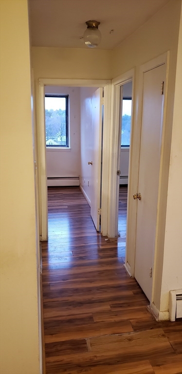 6 Hayes Road, Unit 25 Boston, MA 02131 - Photo 15 of 39 a view of a hallway with wooden floor and a bathroom