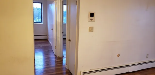 a view of a hallway with wooden floor