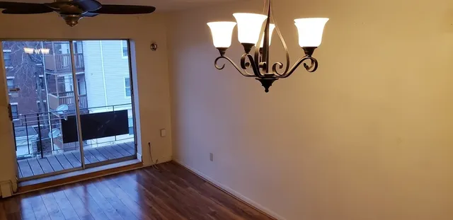 a view of a livingroom with wooden floor and a window